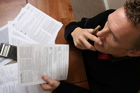 worried-man-with-paperwork