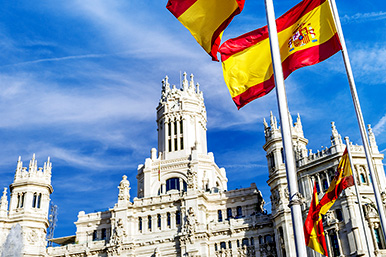 Spanish flag and building: Spain's budget and 2021 taxes